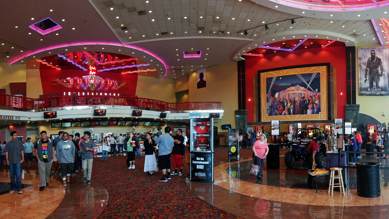 Bustling movie theater lobby with people gathering before a show, showcasing the vibrant and communal cinema experience.