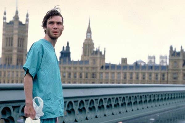 Cillian Murphy as Jim in 28 Days Later walking across London bridge in hospital gown.