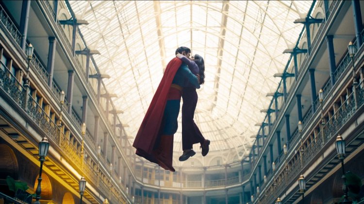 Superman (David Corenswet) and Lois Lane (Rachel Brosnahan) kiss while floating midair in a sunlit atrium in James Gunn's Superman (2025)